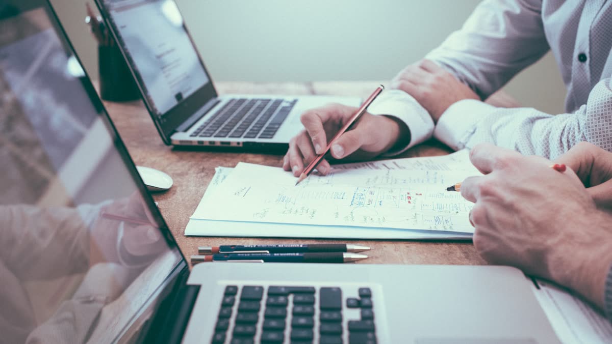 Business owner comparing WhatsApp CRM options with charts and notes