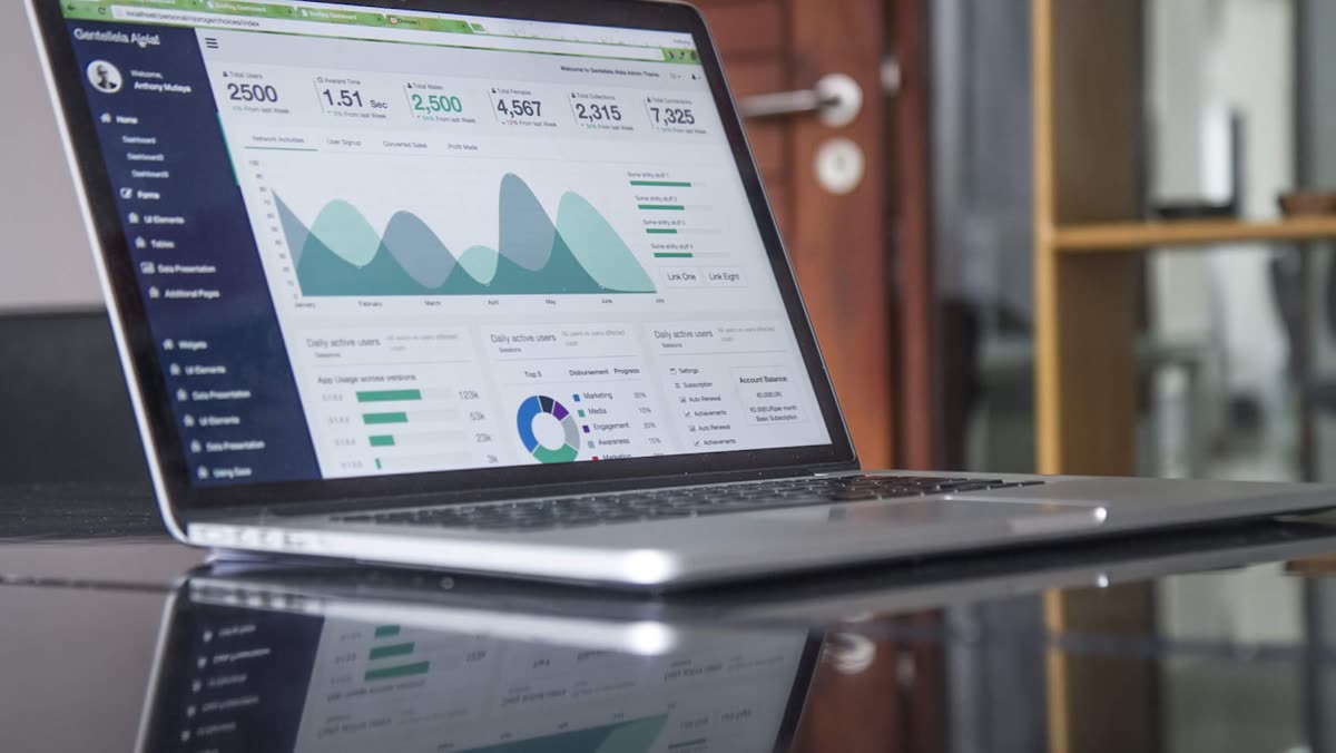 Laptop analytics desk used to break down WhatsApp CRM pricing costs